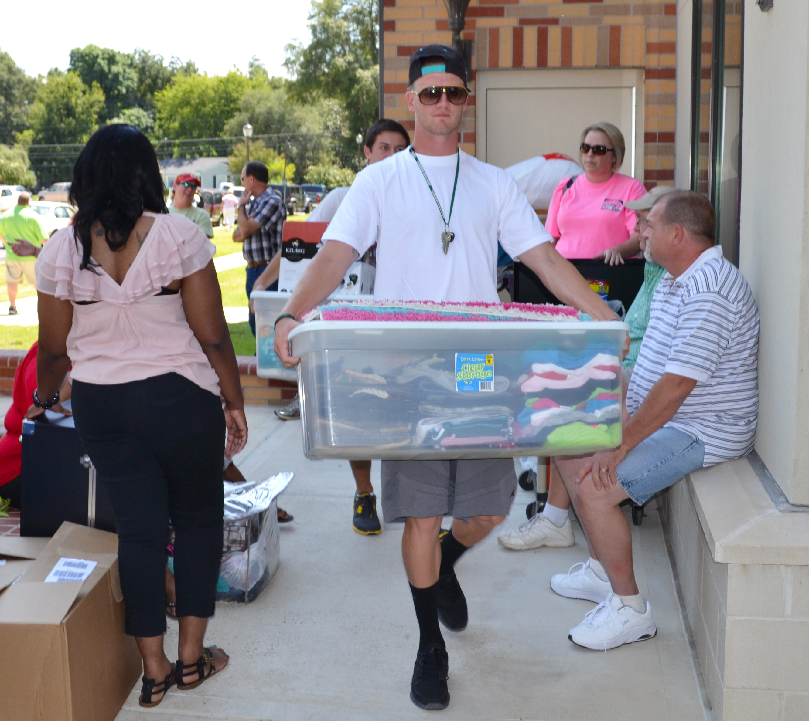 Athletes help carry items in residence halls. 